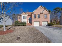 Brick two-story house with attached two-car garage and manicured landscaping at 3643 Southland Ne Dr, Buford, GA 30519