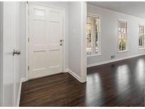 Bright entryway features beautiful dark wood floors and a white front door at 2540 Thornton Dr, Atlanta, GA 30349