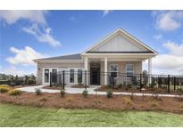 Brick house with a front porch and black metal fence, landscaped yard at 630 Pineberry Ct, Grayson, GA 30017