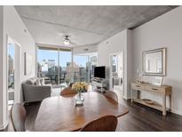 Modern dining area with wooden table and chairs, offering city views at 860 Peachtree Ne St # 2605, Atlanta, GA 30308