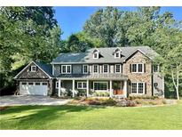 Two-story home with stone accents and a beautifully landscaped lawn at 4152 Club Dr, Atlanta, GA 30319
