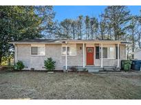 Ranch style home with red front door and landscaped yard at 2040 Forrest Park Se Rd, Atlanta, GA 30315