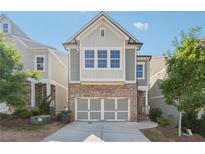 Brick and siding two-story home with a two-car garage at 667 Crosshaven Dr, Marietta, GA 30066