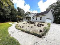 Two-story house with landscaped yard and large driveway at 20 Mountain Ridge Ne Rd, White, GA 30184