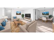Bright living room showcases neutral tones, wood floors, and comfortable seating at 3091 Colonial Way # E4, Chamblee, GA 30341