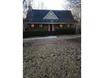 Charming single-Gathering home featuring a cozy porch and well-maintained front yard landscaping at 95 Jenna Ln, Covington, GA 30016