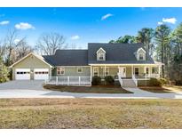 Charming house with a wraparound porch and attached two-car garage at 3133 Callie Still Rd, Lawrenceville, GA 30045