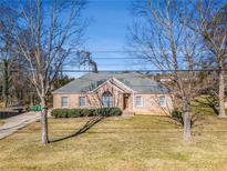 Brick ranch house with a landscaped lawn and mature trees at 3542 Linecrest Rd, Ellenwood, GA 30294