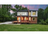 Modern two-story home with wood siding, deck, and landscaped lawn at 4217 Danforth Sw Rd, Atlanta, GA 30331