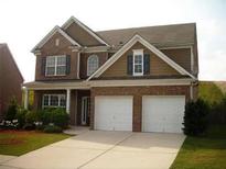 Two-story brick home with a large driveway and landscaped yard at 1710 Rutland Pass Dr, Lawrenceville, GA 30045