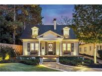 Charming brick home with a welcoming front porch and landscaping at 566 Church Ne St, Marietta, GA 30060