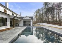 Luxury home with inviting pool, expansive patio, and outdoor kitchen at 122 Owens Mill Pl, Canton, GA 30115