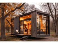 Modern tiny home with large windows and wood siding, nestled amongst autumn trees at 254 Elizabeth Ne St, Atlanta, GA 30307