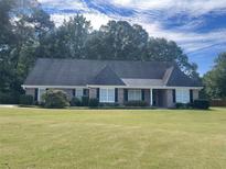 Brick ranch home with a large yard and mature trees at 130 Fiddle Crk, Social Circle, GA 30025