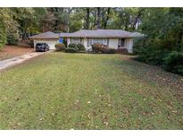 Ranch style home with a large front yard and detached garage at 1141 Goodwin Ne Pl, Brookhaven, GA 30319