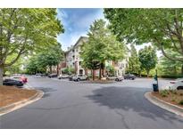 Apartment building with lush landscaping, ample parking and beautiful tree lined entry at 1965 Nocturne Dr # 1209, Alpharetta, GA 30009