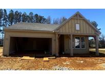 Charming, single story home with an attached two-car garage and craftsman style exterior details at 106 Cherry Glen Way, Euharlee, GA 30145