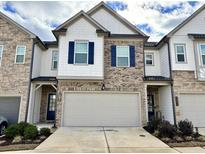 Brick and shingle two-story townhome with attached garage at 1395 Ben Park Way, Grayson, GA 30017