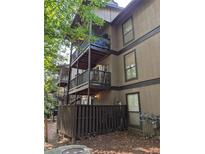 Multi-level building with private balconies and a fenced backyard at 710 River Run Dr, Atlanta, GA 30350