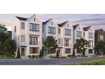 Exterior of three-story townhomes with white brick and dark trim at 2641 Mackintosh Ct # 9, Brookhaven, GA 30319