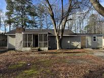 Ranch home with screened porch and mature trees at 3965 Pecan Rd, Loganville, GA 30052