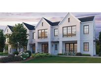 Three-unit townhome building, white brick exterior, landscaping, and a grassy lawn at 1341 Grannysmith Trce # 45, Brookhaven, GA 30319