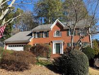 Brick house with a two-car garage and mature landscaping at 2640 Timberloch Ct, Snellville, GA 30039