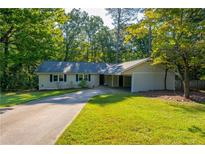 Ranch house with carport and spacious yard at 5305 Pilgrim Point Rd, Cumming, GA 30041