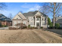 Brick two-story home with a large front yard and professionally landscaped grounds at 3352 Forest Vista Dr, Dacula, GA 30019