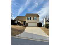 Two-story house with attached garage and driveway at 1280 Sweet Woods Dr, Lawrenceville, GA 30044