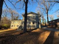 Gray brick ranch home with steps leading to the entrance and a spacious yard at 2668 Woodfen Dr, Ellenwood, GA 30294