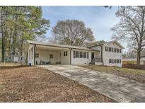 Ranch style home with carport and landscaped yard at 4809 Hemlock Sw Dr, Austell, GA 30106
