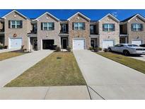 New townhome community with inviting front yards and attached garages at 449 Broder Farms Dr, Stockbridge, GA 30281