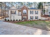 Two-story house with stone accents and a landscaped yard at 3235 Crestview Dr, Cumming, GA 30041