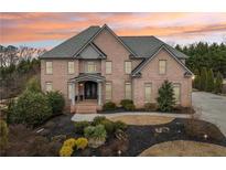 Stunning brick home featuring mature landscaping and a welcoming entrance at 206 Woodridge Pkwy, Canton, GA 30115