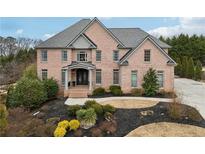Two-story brick home with landscaped yard and large driveway at 206 Woodridge Pkwy, Canton, GA 30115