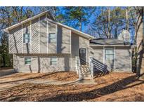 Gray two-story house with white accents and stone detailing at 3485 Tarragon Dr, Decatur, GA 30034