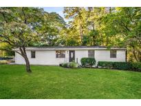 Charming ranch home with a white brick exterior and well-manicured lawn at 330 Banberry Sw Dr, Atlanta, GA 30315