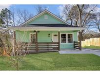 Charming renovated bungalow with a welcoming front porch and landscaped lawn at 510 Woodlawn Nw Ave, Atlanta, GA 30318