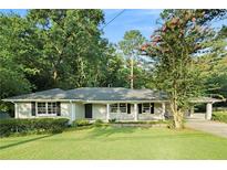 Ranch style home with carport, manicured lawn and mature trees at 2378 Shallowford Ne Rd, Atlanta, GA 30345