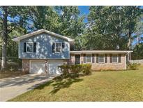 Ranch style home with two car garage and landscaped yard at 586 Chris Cir, Lawrenceville, GA 30044