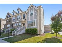 Modern three-story townhome with gray siding and stone accents at 5534 Radford Loop, Fairburn, GA 30213
