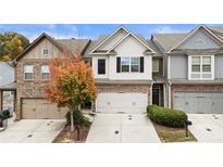 Three-unit townhome complex with two-car garages and attractive landscaping at 5016 Whiteoak Se Pointe, Smyrna, GA 30080