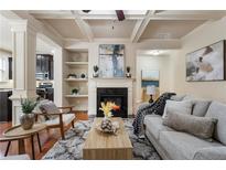 Inviting living room with fireplace, stylish decor, hardwood floors, coffered ceilings, and comfortable seating at 5016 Whiteoak Se Pointe, Smyrna, GA 30080
