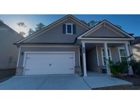 Gray house with white garage door and front porch at 730 Lanarck Way, Peachtree City, GA 30269