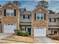 Two-story townhome with stone accents and two-car garage at 103 Linton Dr # 1, Acworth, GA 30102