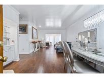 Elegant dining room features hardwood floors, chandelier, and views into living room at 2865 Lenox Ne Rd # 211, Atlanta, GA 30324