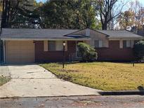 Brick ranch house with attached garage and landscaped lawn at 2922 Eleanor Ter, Atlanta, GA 30318