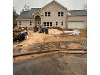 Two-story brick house with a two-car garage under construction with grey shingles at 4648 Lantern Ct, Lithonia, GA 30038