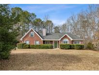 Brick house with a green door and well-manicured lawn at 300 Huntington St, Covington, GA 30016